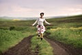Joyful woman running on a countryside road Royalty Free Stock Photo