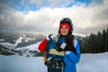 Joyful woman snowboarder in winter at ski resort Royalty Free Stock Photo