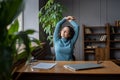 Joyful woman stretching relaxed with closed eyes enjoy break after work done sit with closed laptop Royalty Free Stock Photo