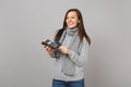 Joyful woman in sweater, scarf hold wireless modern bank payment terminal to process, acquire credit card payments Royalty Free Stock Photo