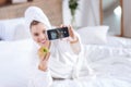 Joyful woman taking selfie with apple on bed Royalty Free Stock Photo