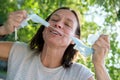 Joyful woman tears the medical mask on her face, she smiles and feels free. Concept of defeating the virus, the end of Royalty Free Stock Photo