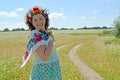The joyful woman with a wreath on the head against the background of the blossoming buckwheat field Royalty Free Stock Photo