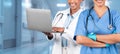 A joyful women healthcare professional in a white coat uses a laptop