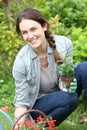 Joyful woung woman gardening Royalty Free Stock Photo