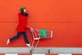 Happy Woman with Shopping Cart Ready for Christmas Sale