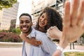 Joyful young african friends looking at camera, fooling around walking outdoors daytime. Royalty Free Stock Photo