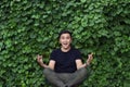 Joyful young asian man posing yoga Royalty Free Stock Photo