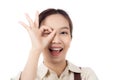 Joyful young asian woman wearing apron is barista attire gesturing OK with her hand, expressing satisfied. Royalty Free Stock Photo