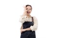 Joyful young asian woman wearing apron is barista attire gesturing OK with her hand, expressing satisfied and approval. Royalty Free Stock Photo