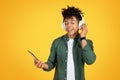 Joyful young black guy listening to music, using app Royalty Free Stock Photo