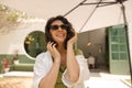 Joyful young brunette caucasian woman is having good time outdoors. Royalty Free Stock Photo