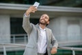 Joyful young businessman in suit taking a selfie outdoors Royalty Free Stock Photo