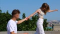 Joyful young Caucasian couple man and woman walking in city and laughing spending day together. Happiness. Boyfriend and Royalty Free Stock Photo