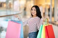 Joyful young eastern woman showing her purchases Royalty Free Stock Photo