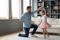 Happy different generations family dancing to music at home.