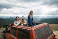 Joyful young friends travelling in the off road car Royalty Free Stock Photo