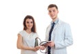 Joyful young girl stands with the tonometer on the arm next to the smiling doctor smock