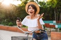 Joyful young girl in summer clothes riding bicycle Royalty Free Stock Photo