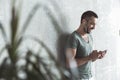 Joyful young guy is listening to music using his phone Royalty Free Stock Photo