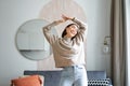 Joyful young korean woman dancing, raising hands up and looking upbeat, feeling healthy and upbeat