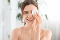 Joyful young lady removing makeup from her eyes Royalty Free Stock Photo