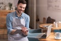 Joyful young man smiling and making notes. Royalty Free Stock Photo