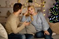 Joyful young man and woman having conversation, celebrating Christmas Royalty Free Stock Photo