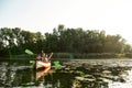 Joyful young mixed couple spending time together, kayaking on river surrounded by wild nature Royalty Free Stock Photo