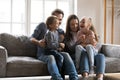 Joyful young parents having fun with little laughing children. Royalty Free Stock Photo