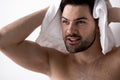 Joyful young shirtless man is wiping his head Royalty Free Stock Photo