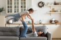 Overjoyed small kid girl practicing acroyoga with mom.