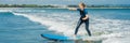 Joyful young woman beginner surfer with blue surf has fun on small sea waves. Active family lifestyle, people outdoor