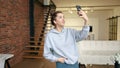 Joyful Young Woman Captures Selfie in Chic Urban Loft. RED V-RAPTOR 8K RAW