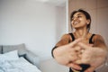 Joyful young woman doing morning gymnastics at home Royalty Free Stock Photo