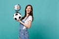 Joyful young woman football fan support favorite team with soccer ball, world globe isolated on blue turquoise
