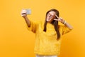 Joyful young woman in fur sweater heart glasses showing victory sign doing taking selfie shot on mobile phone isolated Royalty Free Stock Photo