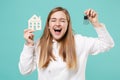 Joyful young woman girl in casual white hoodie posing isolated on blue turquoise background studio portrait. People Royalty Free Stock Photo