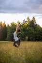 Joyful young woman leaping in a meadow
