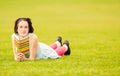 Joyful young woman reading a book outside and relaxing Royalty Free Stock Photo