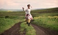 Joyful young woman running on a countryside road Royalty Free Stock Photo