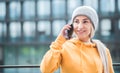 Joyful young woman on the smartphone. Outdoors daylight. Trendy girl talks on mobile phone Royalty Free Stock Photo