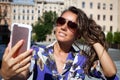 Joyful young women making selfie by her smart phone