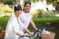 joyful young women riding bicycle together Royalty Free Stock Photo