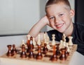 Joyfull boy plays chess