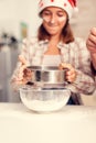 Joyfull child making cookies on christmas day sifting flour