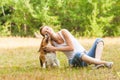 Joyfull woman and her dog in a summer meadow Royalty Free Stock Photo
