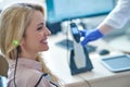 Pleased female patient smiling during the audiometry test