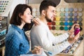 Joyous couple examining various paints in paint store Royalty Free Stock Photo