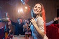 Joyous female emotionally sing in karaoke Royalty Free Stock Photo